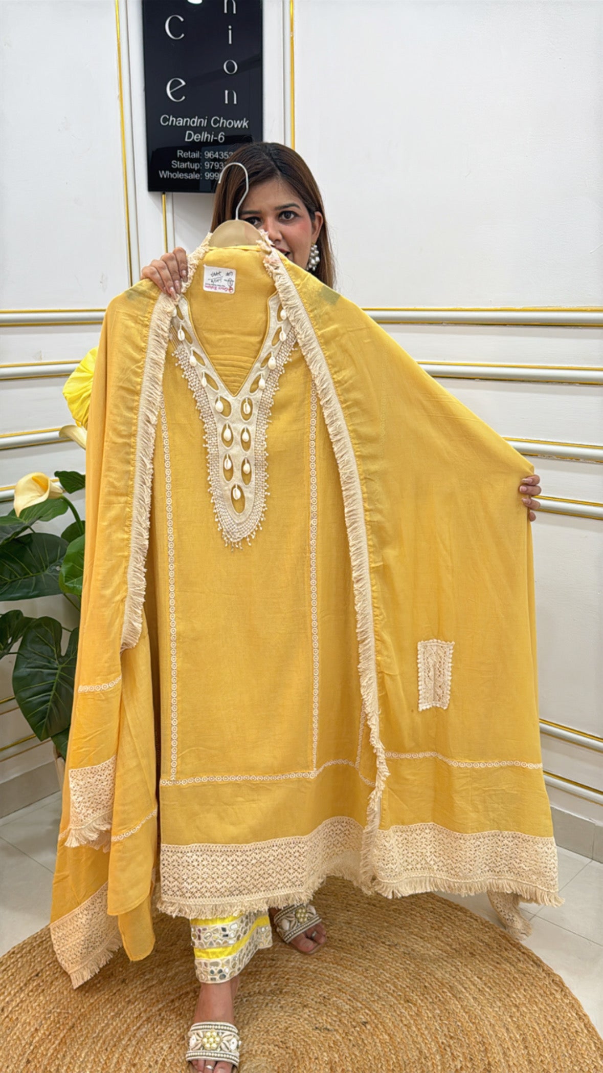 Elegant yellow kurta with embroidered neckline and lace trim, perfect for festive occasions